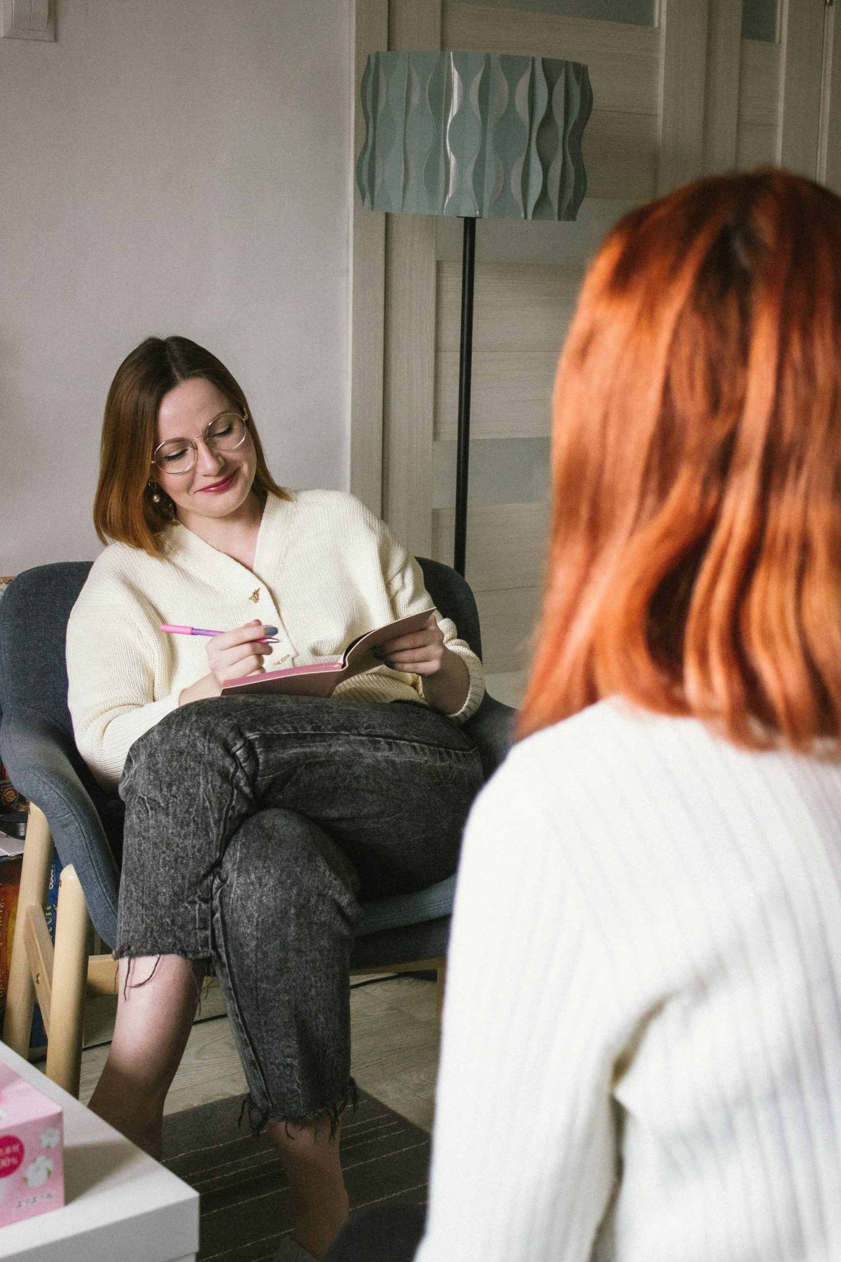 A small peer support group seated in a circle mid-conversation